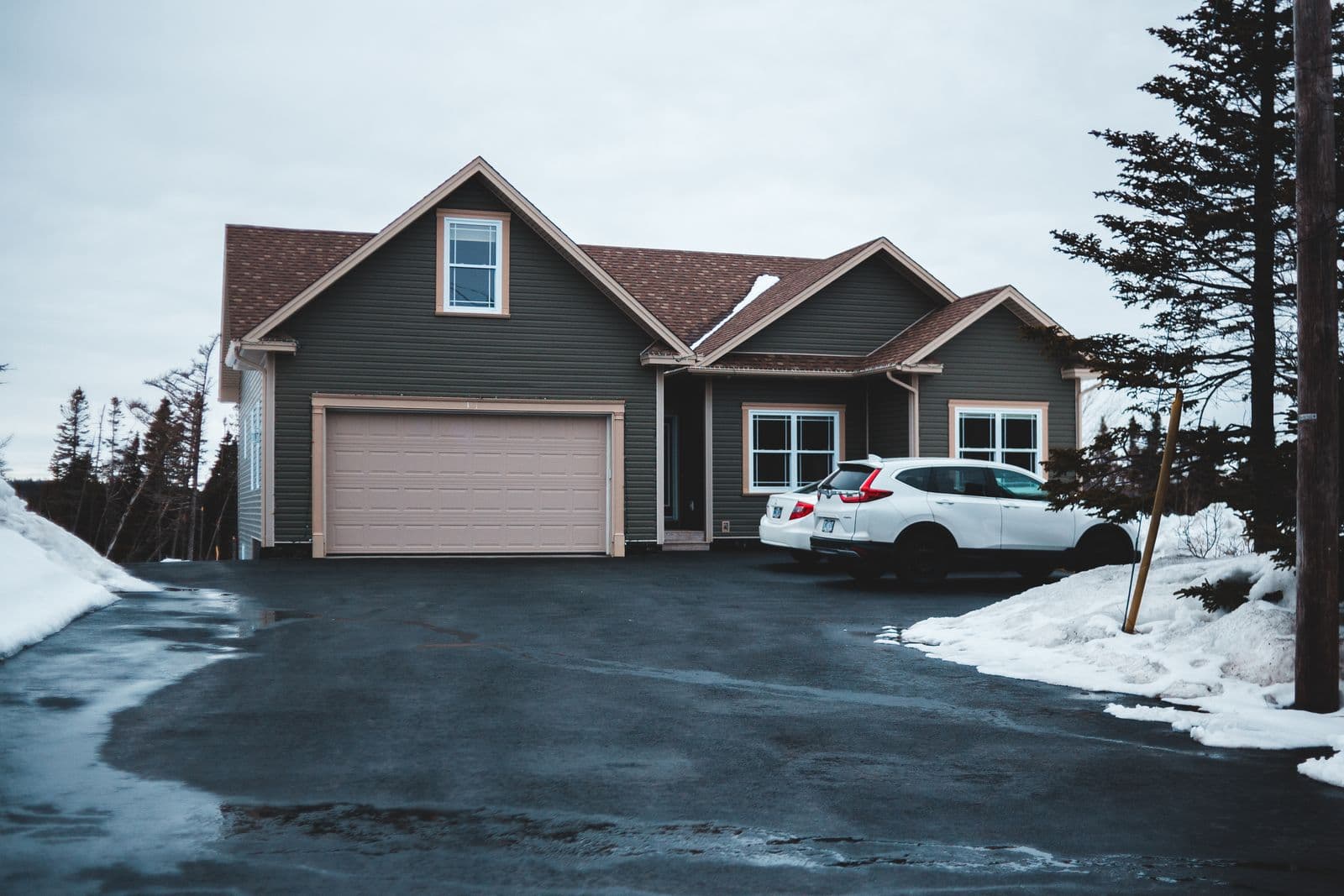 Freshly paved residential asphalt driveway at a New Hampshire home